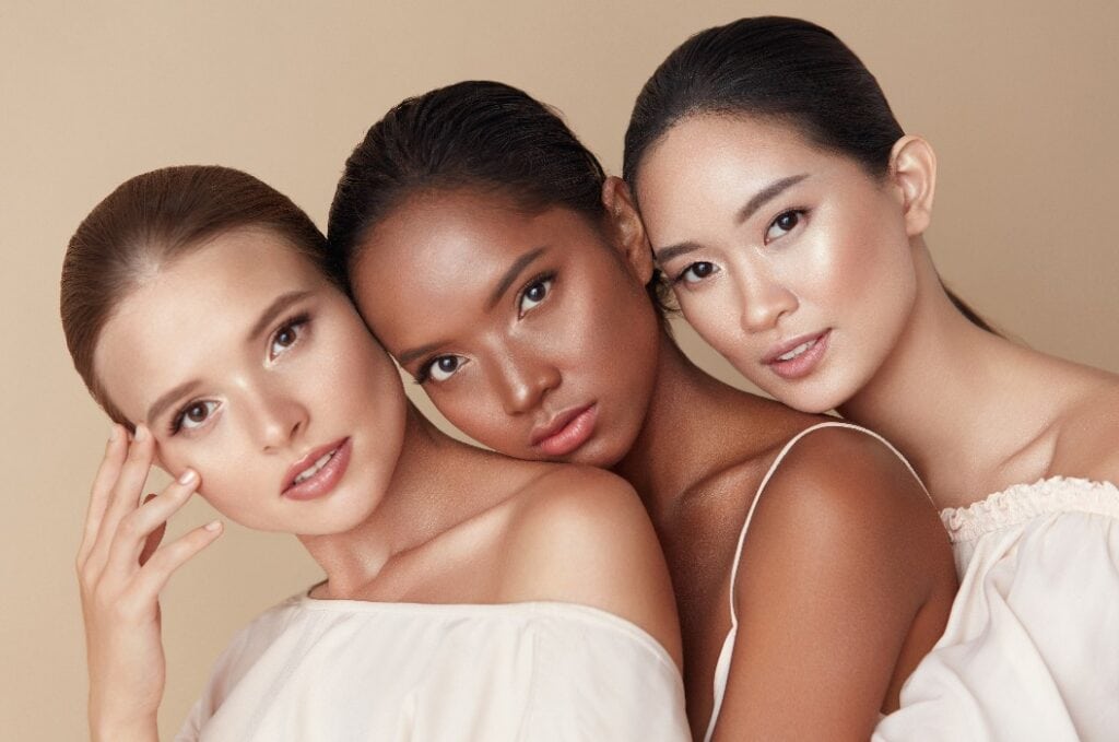 Beauty. Group Of Diversity Models Portrait. Multi-Ethnic Women With Different Skin Types Posing On Beige Background. Tender Multicultural Girls Standing Together And Looking At Camera.