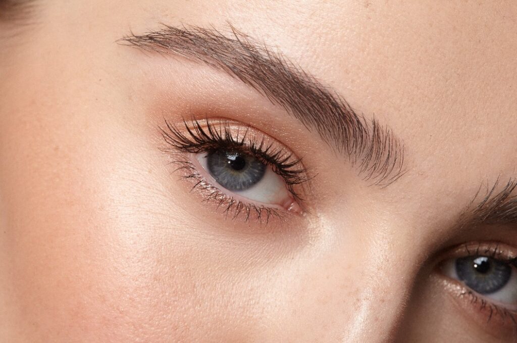 young girl open eyes with natural makeup close up